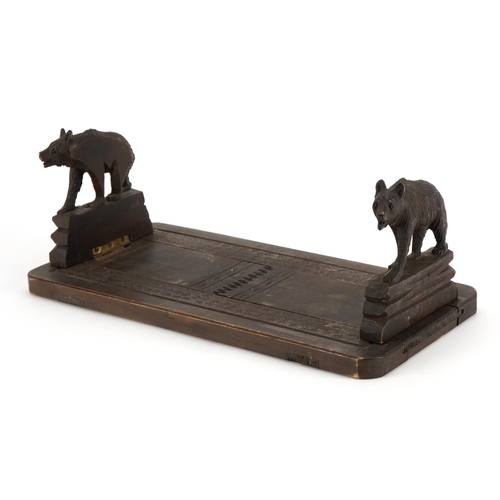 624 - Black Forest extending book slide carved with two bears, 30.5cm wide when closed