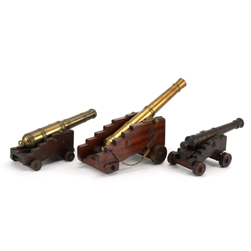 330 - Three 19th century and later Naval interest bronze model table cannons on hardwood stands including ... 