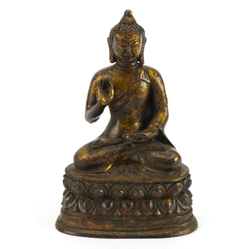 202 - Chino Tibetan partially gilt bronze figure of seated Buddha, character marks to the reverse, 19.5cm ... 