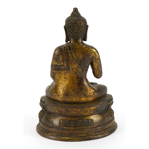 202 - Chino Tibetan partially gilt bronze figure of seated Buddha, character marks to the reverse, 19.5cm ... 