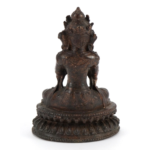 621 - Chino Tibetan partially gilt bronze figure of seated Buddha, 19cm high