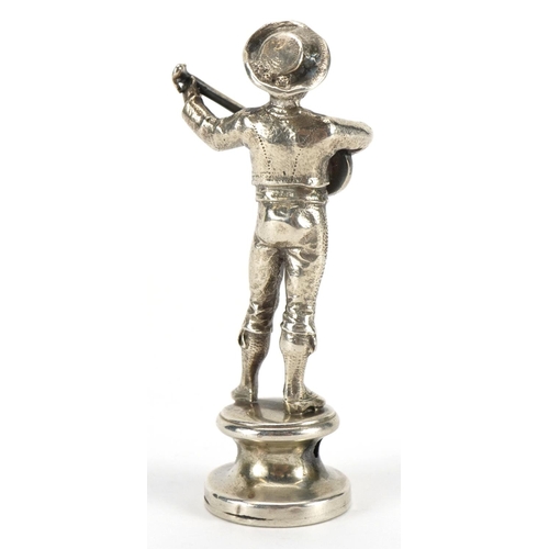 56 - Unmarked silver pipe tamper with seal in the form of a Mexican musician, 5.5cm high, 21.3g
