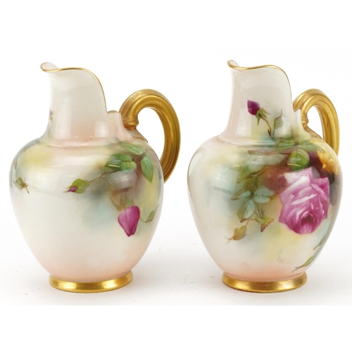 93 - Pair of Royal Worcester blush ivory jugs hand painted with roses, each numbered 1094, each 13cm high