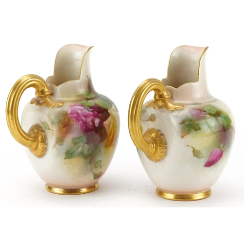 93 - Pair of Royal Worcester blush ivory jugs hand painted with roses, each numbered 1094, each 13cm high