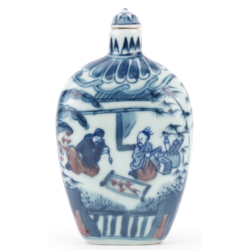 575 - Chinese blue and white with iron red porcelain snuff bottle hand painted with figures in a palace se... 