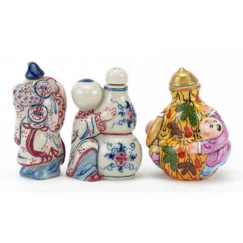 784 - Three Chinese porcelain figural snuff bottles including one hand painted with leaves, the largest 5.... 