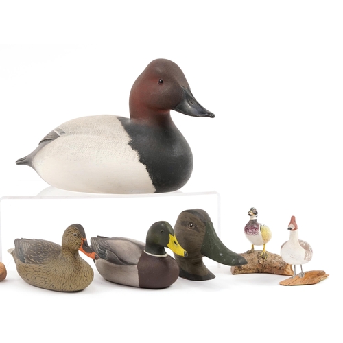 654 - Eight hand painted wooden duck decoys and figures, some signed Parker, the largest 34cm in length