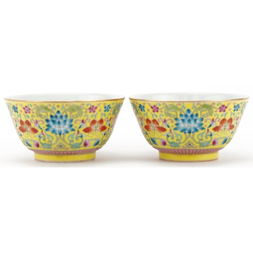 255 - Pair of Chinese porcelain yellow ground bowls hand painted with flowers, four figure character marks... 