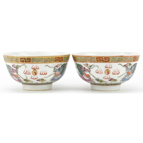 198 - Pair of Chinese porcelain bowls hand painted in the famille rose palette with dragons chasing the fl... 