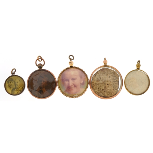 2094 - Five yellow metal open lockets including one marked 9ct gold, the largest 3.2cm in diameter