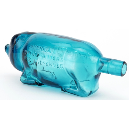 247 - Blue glass bottle in the form of a pig advertising Suffolk Bitters, 24cm in length