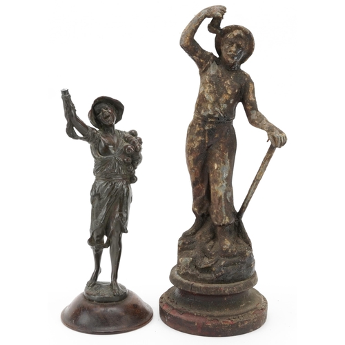 693 - Two antique spelter figures of a miner and beggar boy, the largest 37cm high