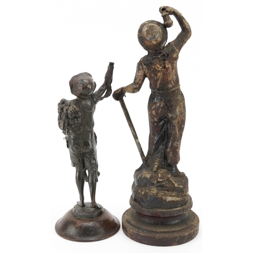 693 - Two antique spelter figures of a miner and beggar boy, the largest 37cm high