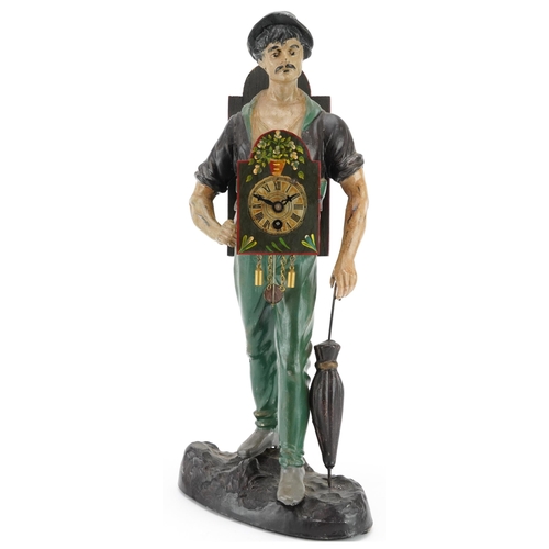 692 - Novelty painted spelter table clock in the form of a gentleman with an umbrella, 43.5cm high