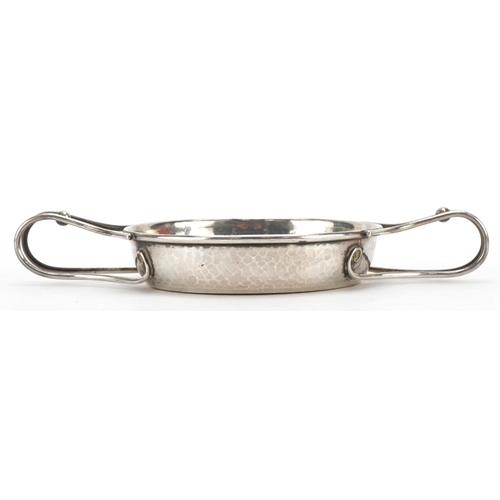 297 - A E Jones, Arts & Crafts circular silver quaich with twin handles and planished body numbered 501 to... 