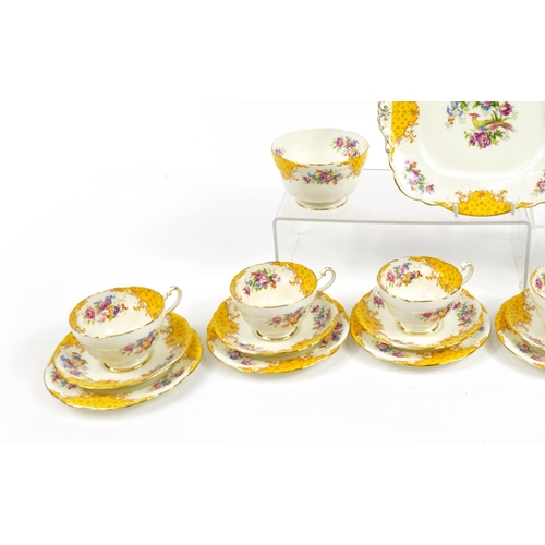 594 - Paragon yellow ground six place tea service decorated with birds amongst flowers comprising six trio... 