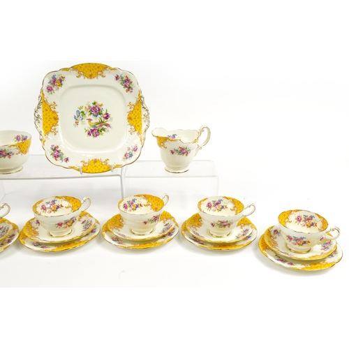 594 - Paragon yellow ground six place tea service decorated with birds amongst flowers comprising six trio... 