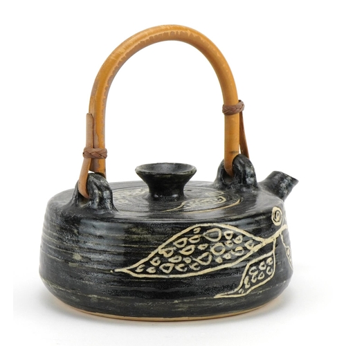 737 - Paul Whalley, studio pottery teapot with bamboo handle, hand painted with stylised motifs, 21cm in l... 