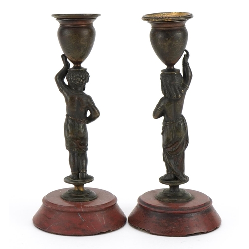 18 - Pair of 19th century French patinated bronze Blackamoor candlesticks raised on circular rouge marble... 