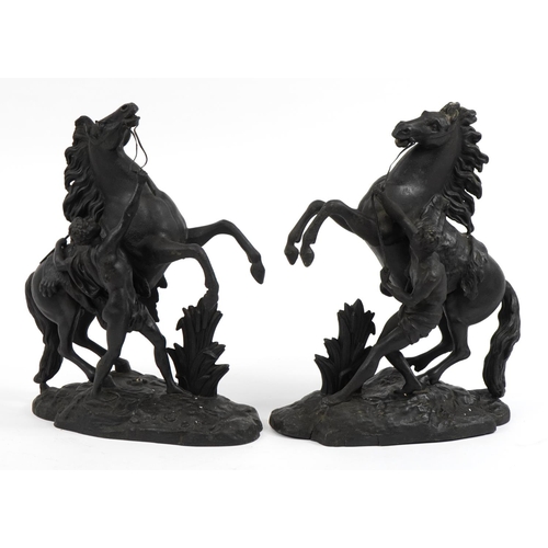 476 - After Guillaume Coustou the Elder, Pair of patinated spelter Marly horses with trainers, 40cm high