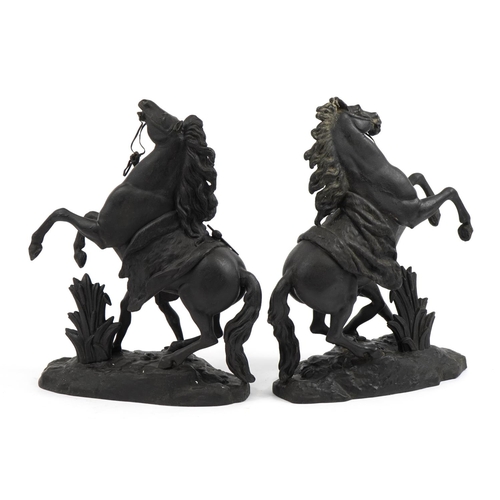 476 - After Guillaume Coustou the Elder, Pair of patinated spelter Marly horses with trainers, 40cm high