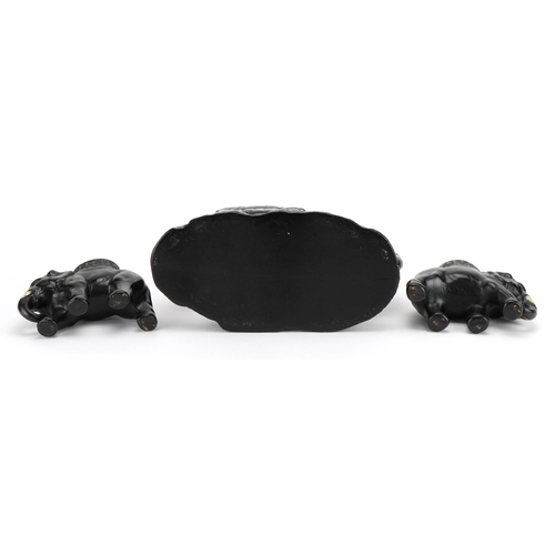 786 - Three early 20th century black painted pottery elephant design planters, the largest 21cm in length