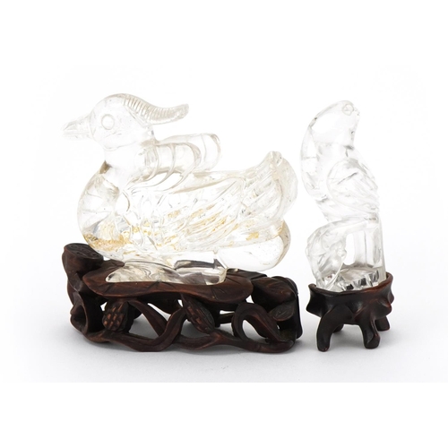 462 - Two Chinese rock crystal carvings raised on carved hardwood stands including one of a duck, the larg... 