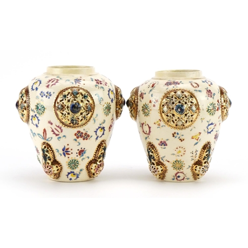35 - Zsolnay Pecs, pair of Hungarian vases with pierced roundels decorated with flowers, each with Fische... 