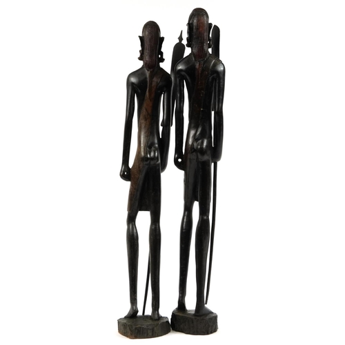 434 - Large pair of African carved figures of tribes people holding spears, the largest 79cm high