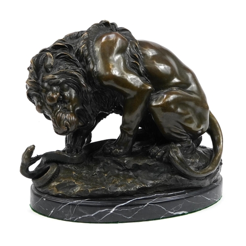 604 - Large patinated bronze study of a lion and serpent signed A Barye, raised on an oval marble base wit... 