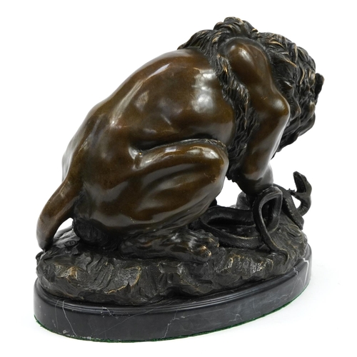 604 - Large patinated bronze study of a lion and serpent signed A Barye, raised on an oval marble base wit... 