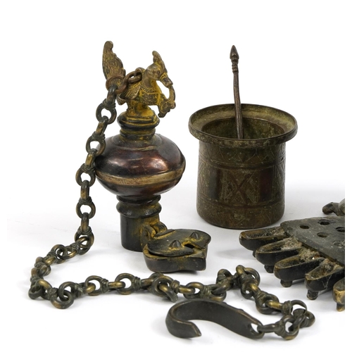 87 - Indian and Middle Eastern metalware including an antique Indian patinated bronze hanging oil lamp in... 