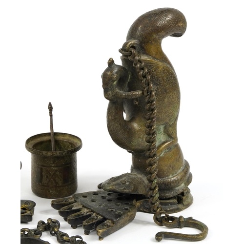 87 - Indian and Middle Eastern metalware including an antique Indian patinated bronze hanging oil lamp in... 