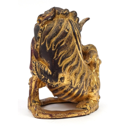 79 - Chinese giltwood carving of a Foo dog, 30.5cm high