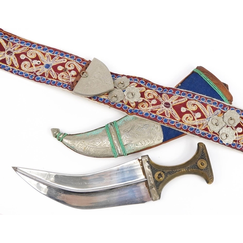 90 - Omani Jambiya dagger with horn handle and white metal mounts on embroidered belt, the dagger 39.5cm ... 