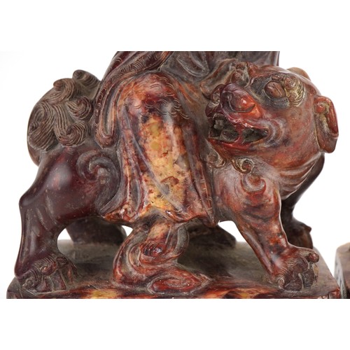 77 - Good pair of Chinese soapstone carvings of Guanyin seated on a mythical animal, each 21cm high