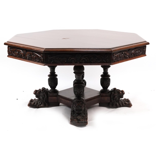 868 - Oak centre table with octagonal top having four frieze drawers on bulbous supports with carved lion ... 