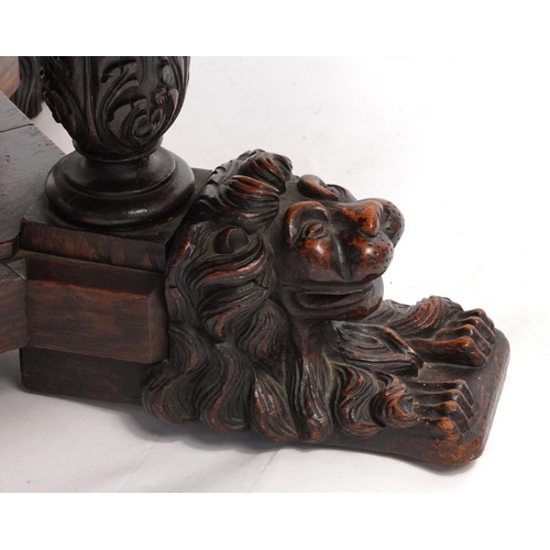 868 - Oak centre table with octagonal top having four frieze drawers on bulbous supports with carved lion ... 