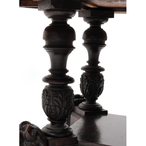 868 - Oak centre table with octagonal top having four frieze drawers on bulbous supports with carved lion ... 