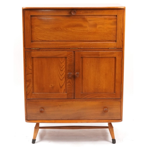 869 - Ercol light elm tallboy fitted with a fall above two cupboard doors and base drawer, 116cm H x 83cm ... 