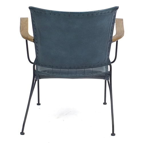 916 - Industrial style wrought iron and green leather open armchair, 74cm high