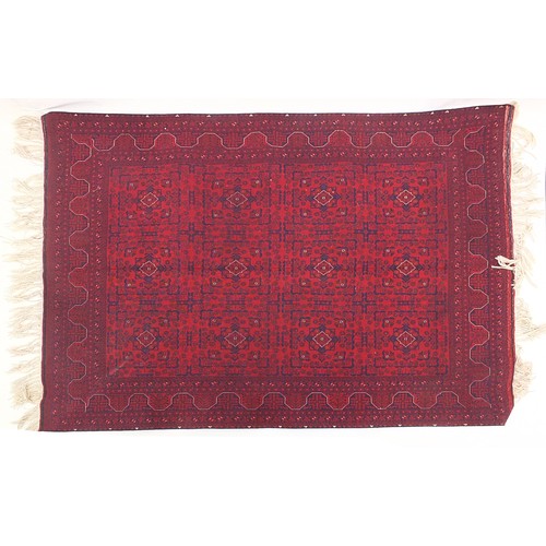 919 - Afghan red and blue ground rug having an all over geometric design, 200cm x 153cm