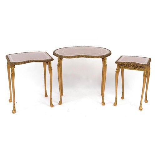 900 - Nest of three kidney shape occasional tables with tooled leather tops and glass inserts, the largest... 