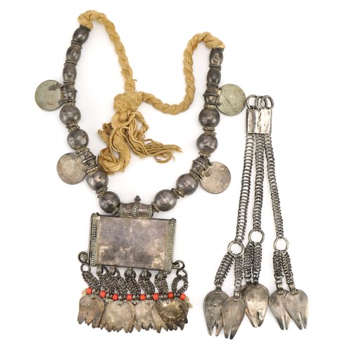 424 - Omani unmarked silver amulet with coins, together with a similar necklace, the amulet 9.5cm wide, to... 