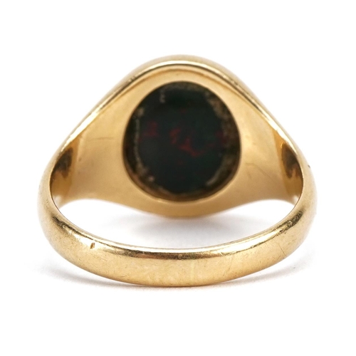 1329 - 18ct gold bloodstone signet ring carved with a double headed eagle heraldic crest, size N/O, 6.6g