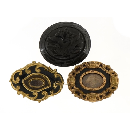 1144 - Three Victorian mourning brooches comprising a jet example and two with enamel and hairwork panels, ... 