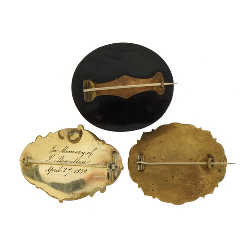 1144 - Three Victorian mourning brooches comprising a jet example and two with enamel and hairwork panels, ... 