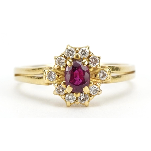 1128 - 18ct gold ruby and diamond cluster ring, the ruby approximately 5.0mm x 3.9mm, size S/T, 4.0g