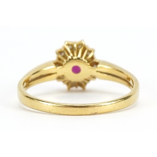 1128 - 18ct gold ruby and diamond cluster ring, the ruby approximately 5.0mm x 3.9mm, size S/T, 4.0g