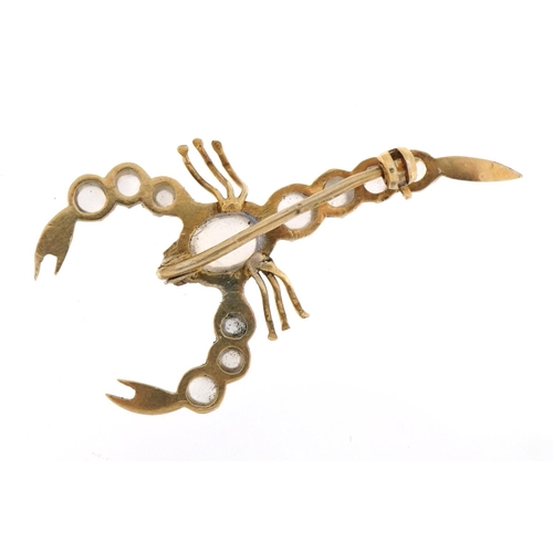 1070 - Unmarked gold cabochon moonstone scorpion brooch, 4.6cm wide, 3.4g